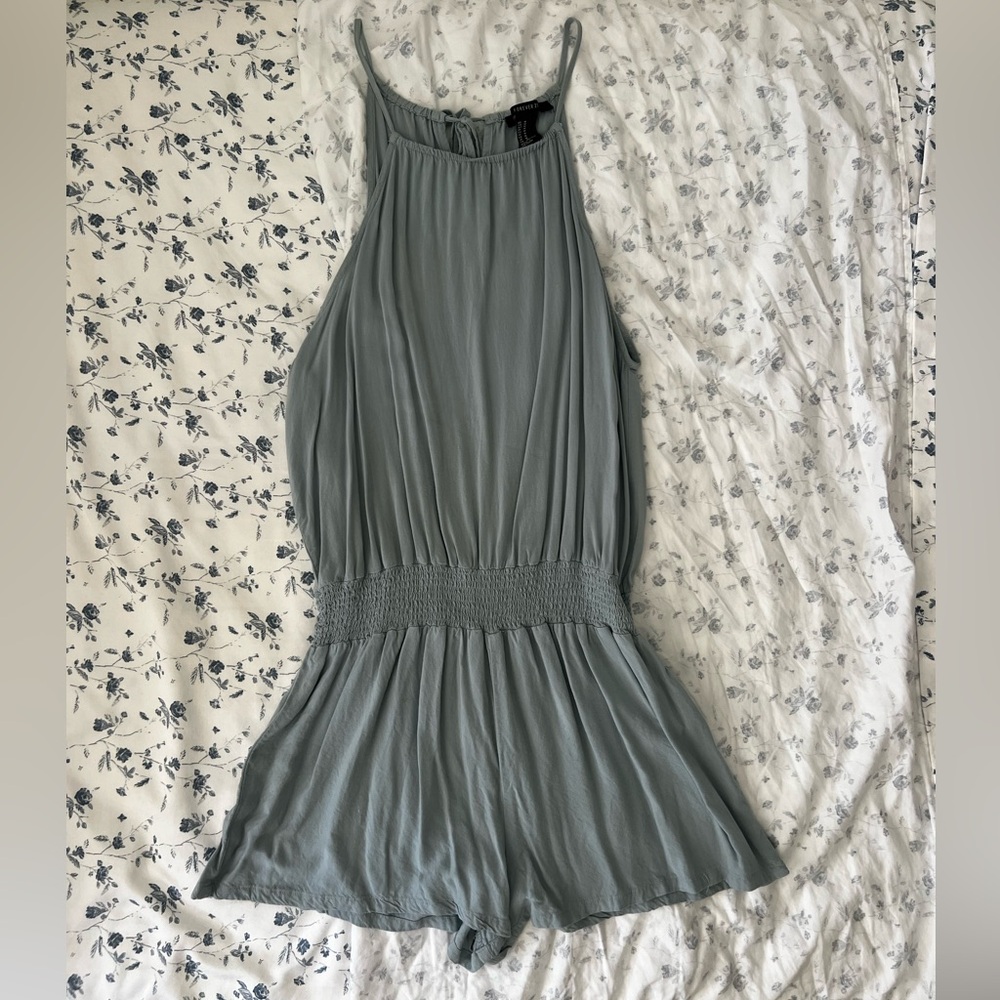 Turquoise colored romper with high neck